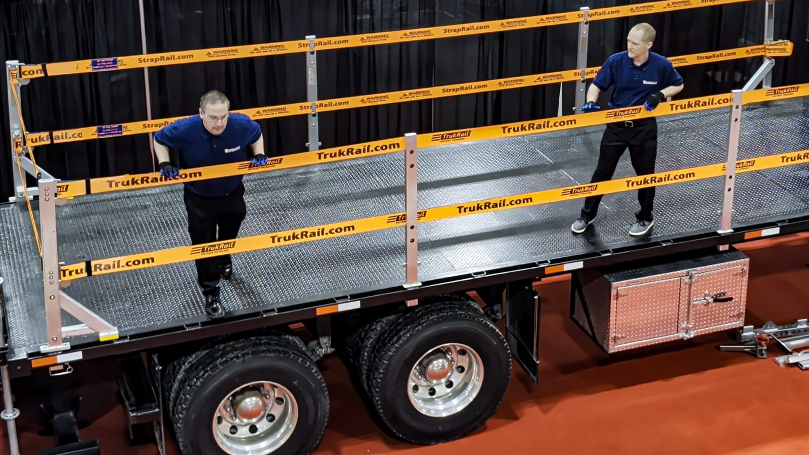 TrukRail installed on a flatbed truck providing fall protection for two workers.