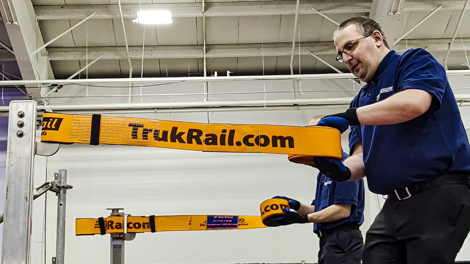 Workers installing TrukRail straps.