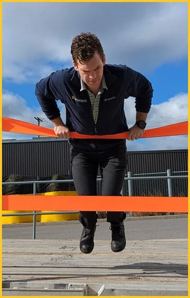 Worker demonstrating the strength of TrukRail straps.